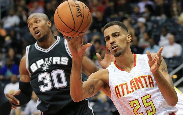 101415 ATLANTA: Hawks guard Thabo Sefolosha, playing in a game for the first time since being injured in a Manhattan night club last season, rebounds against Spurs forward David West during the first period in their preseason basketball game on Wednesday, Oct. 14, 2015, in Atlanta. Curtis Compton / ccompton@ajc.com