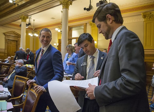 Georgia Senator Greg Dolezal (left), Sen. Matt Brass (center) and Sen. Brian Strickland (right), talk among themselves in the Senate chambers during Sine Die, the last day of the 2019 legislative session, at the Georgia State Capitol in Atlanta, Tuesday, April 2, 2019.  (ALYSSA POINTER/ALYSSA.POINTER@AJC.COM)