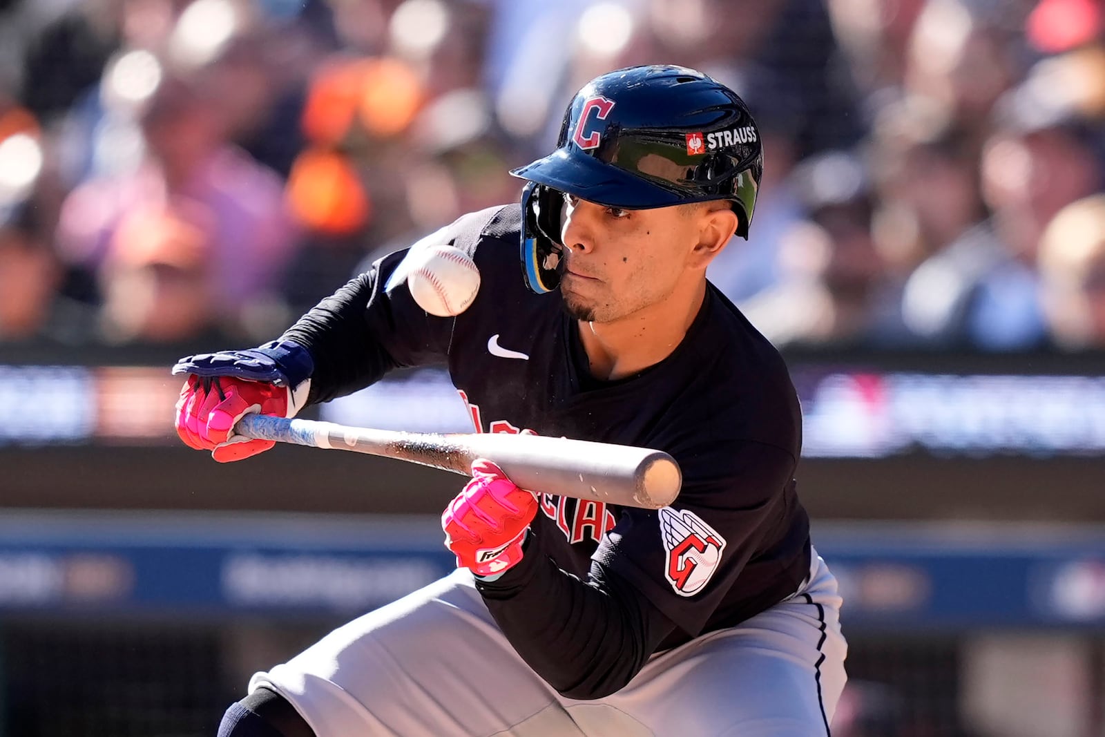 Cleveland Guardians second base Andrés Giménez bunts in the second inning during Game 3 of a baseball American League Division Series against the Detroit Tigers, Wednesday, Oct. 9, 2024, in Detroit. (AP Photo/Carlos Osorio)