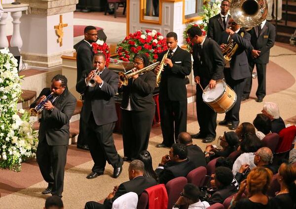 A New Orleans-style funeral procession passed by the coffin of Chris Kelly and his family to lead them out of Jackson Memorial Baptist Church at the conclusion of his funeral on May 9, 2013. AJC photo: Curtis Compton