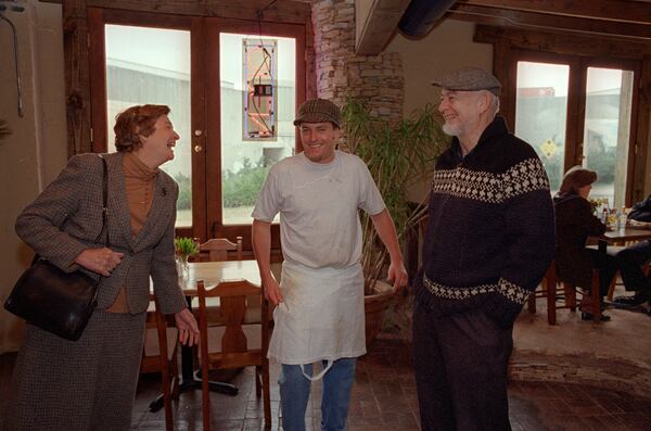 A younger Eric Kaiser, center, talks to customer at one of his ventures, the Cabbagetown Grill.  (AJC Staff Photo/Nick Arroyo)