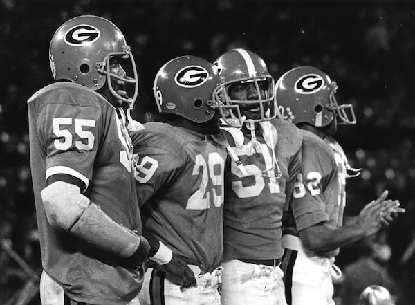 Chuck Kinnebrew, Larry West, Clarence Pope and Richard Appleby watch a game unfold while standing on the Georgia bench in 1974. (UGA photo)