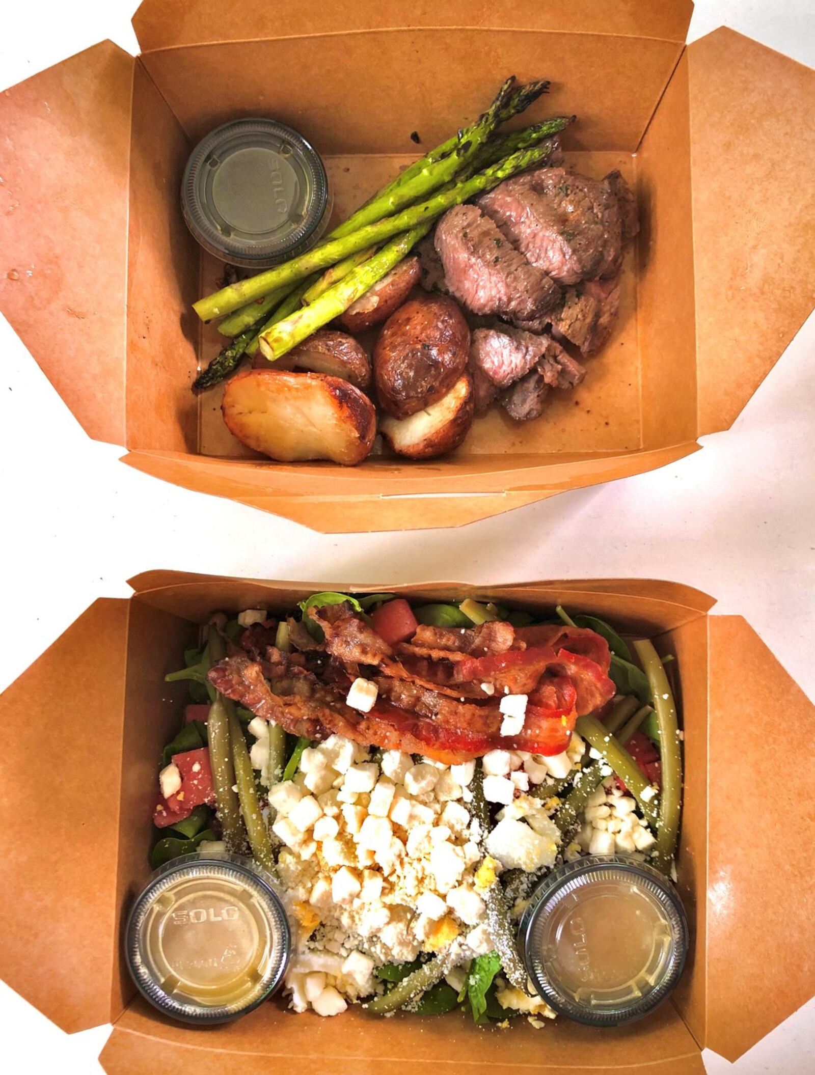 This takeout order includes the steak-frites and watermelon spinach salad from Mediterranea in Grant Park. CONTRIBUTED BY WENDELL BROCK