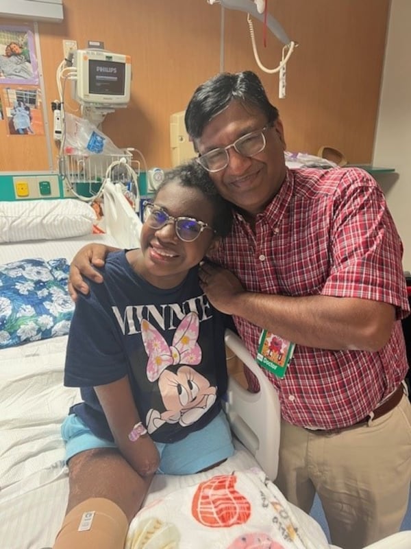 Natalya Manhertz smiles with pediatric anesthesiologist Dr. Vipin Bansal, who alleviated her phantom leg pains post amputation with a ground-breaking nerve stimulator. Courtesy of Manhertz family