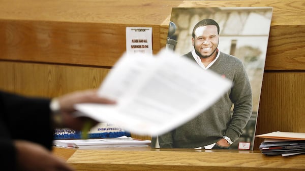 A photo of Botham Jean leans against the judge's bench during the murder trial of ex-Dallas police officer Amber Guyger. Guyger, 31, was convicted of murder Tuesday, Oct. 1, 2019, in the September 2018 murder of Jean, 26, in his apartment.