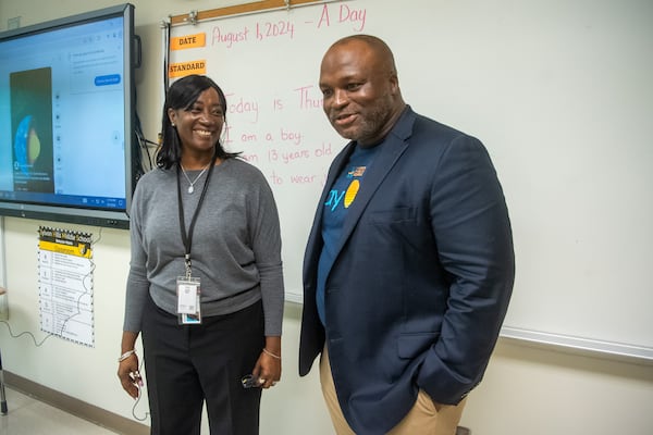 Superintendent Bryan Johnson (right) talks to a faculty member during the first day of class at Sylvan Hills Middle School in Atlanta on Thursday, Aug. 1, 2024. (AJC file)