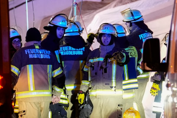 Emergency services work in a cordoned-off area near a Christmas Market, after a car drove into a crowd in Magdeburg, Germany, Friday, Dec. 20, 2024. (AP Photo/Ebrahim Noroozi)