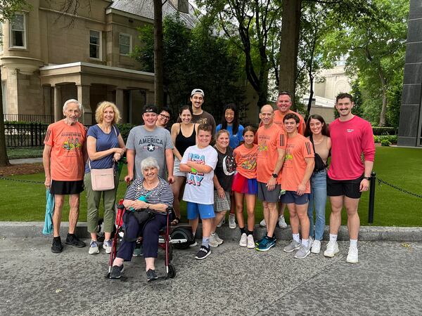 Jere Allen (left) celebrates the finish of his 44th AJC Peachtree Road Race in 2023 with his wife Faye (front) and children and grandchildren.
(Courtesy of Bill Allen)