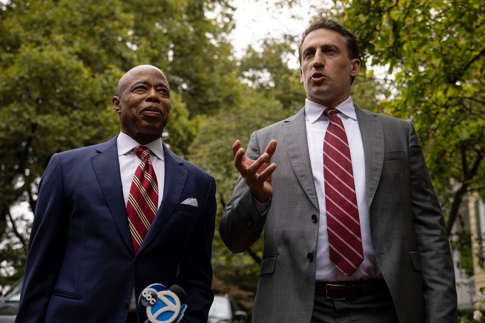 New York City Mayor Eric Adams, left, listens as his attorney Alex Spiro, right, talk to the members of the media as they exit Gracie Mansion, the official residence of the mayor, Thursday, Sept. 26, 2024, in New York. (AP Photo/Yuki Iwamura)