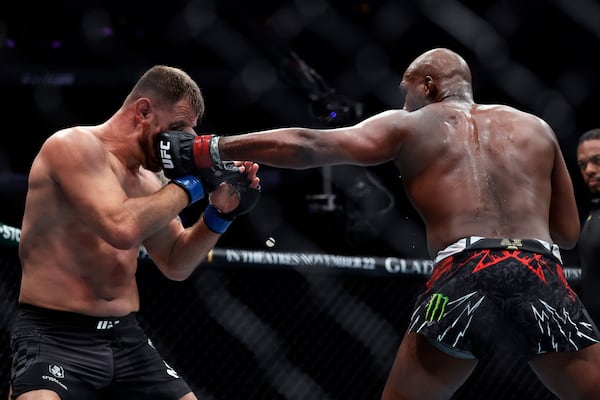 Jon Jones, right, punches Stipe Miocic in a UFC 309 mixed martial arts heavyweight title bout, early on Sunday, Nov. 17, 2024, in New York. (AP Photo/Adam Hunger)