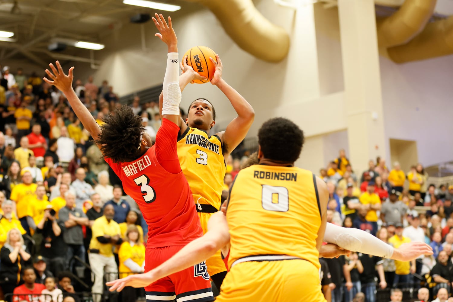 Kennesaw State guard Chris Youngblood (3) goes up for a basket against Liberty Flames guard Isiah Warfield (3) during the second half at the Kennesaw State Convention Center on Thursday, Feb 16, 2023.
 Miguel Martinez / miguel.martinezjimenez@ajc.com