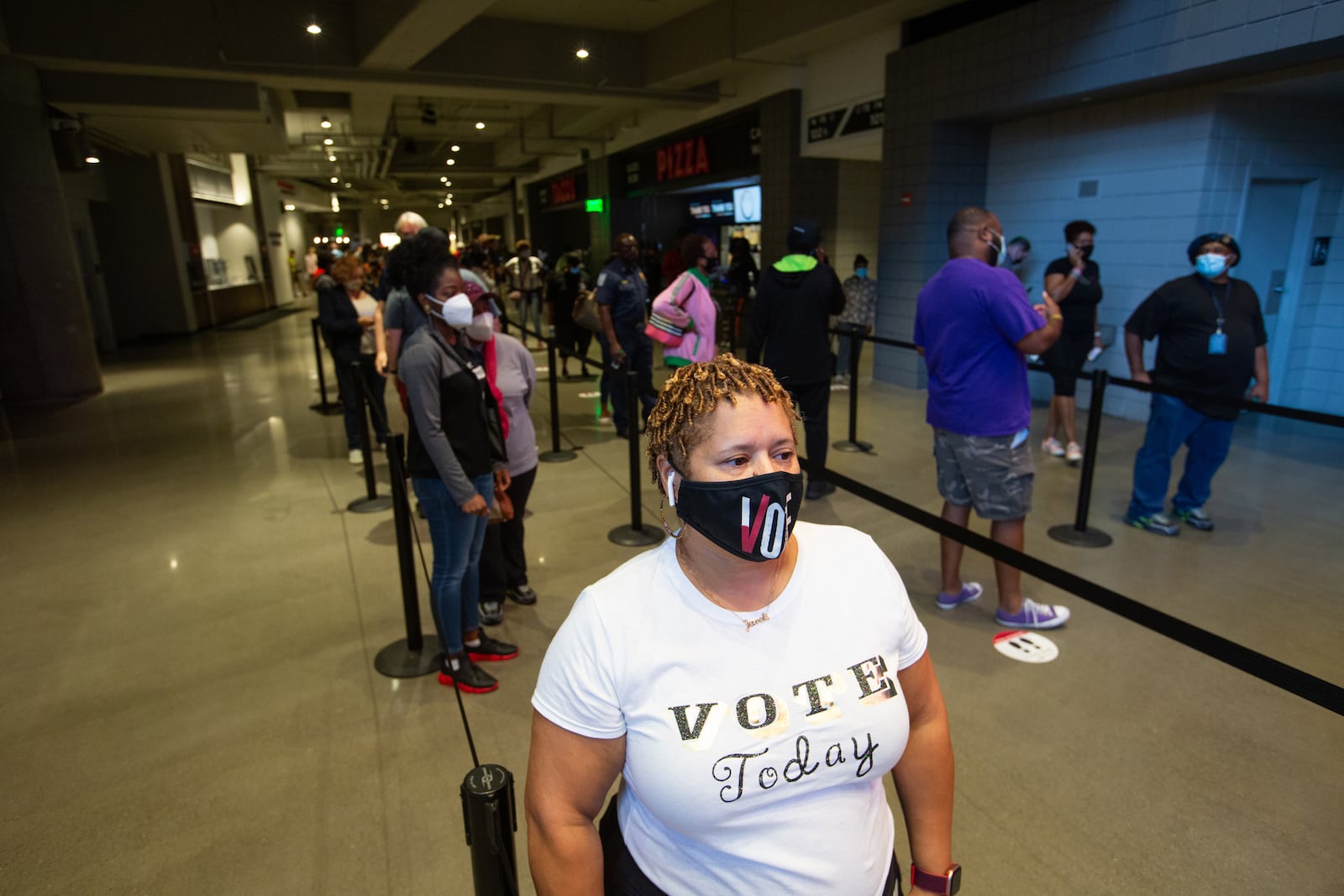 Heather King waits in line at State Farm Arena, Georgia's largest early voting location, to cast her ballot during the first day of early voting in the general election on October 12, 2020 in Atlanta, Georgia. Early voting in Georgia runs from October 12-30. (Jessica McGowan/Getty Images/TNS)