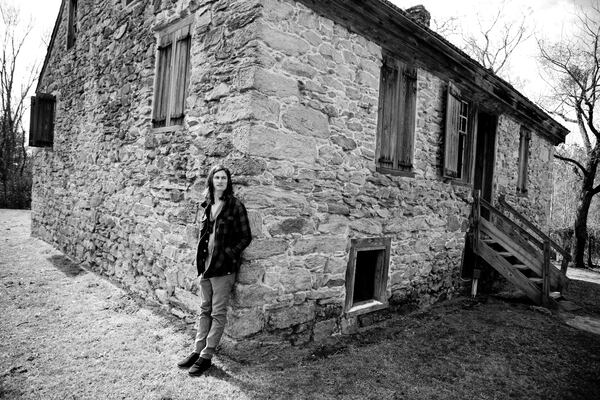 Musician T. Hardy Morris may help raise awareness about preserving Georgia’s past by filming videos with sites on the Georgia Trust for Historic Preservation’s Places in Peril lists as backdrops. Here, Morris stands at the Rock House, built in the 1780s in Thomson.