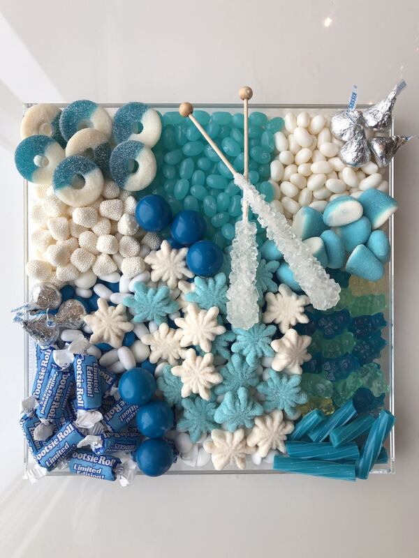 A candy board with a “Frozen” theme is the perfect way to indulge in blue food. Silvery Hershey’s kisses and rock candy swizzle sticks add glitter to the display. CONTRIBUTED BY ELIZABETH SCHMITT