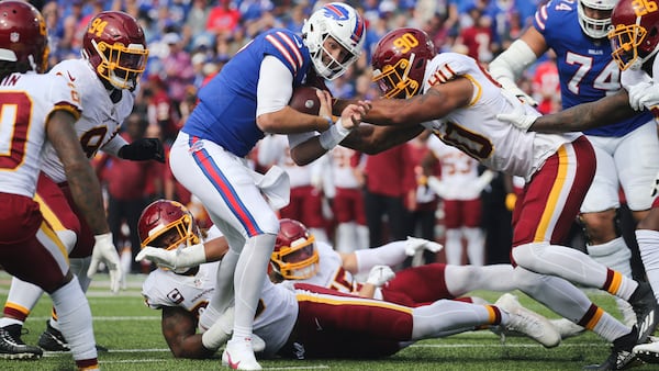 Washington Football Team's Montez Sweat (90) and Chase Young tackle Buffalo Bills quarterback Josh Allen (center) during the first half Sunday, Sept. 26, 2021, in Orchard Park, N.Y. (Jeffrey T. Barnes/AP)