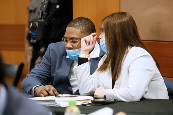 Attorney Nicole Fegan speaks with her client Tenquarius Mender during jury selection. Miguel Martinez / miguel.martinezjimenez@ajc.com