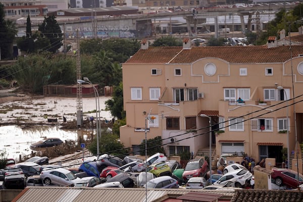 Vehicles are seen piled up after being swept away by floods in Valencia, Spain, Thursday, Oct. 31, 2024. (AP Photo/Alberto Saiz)