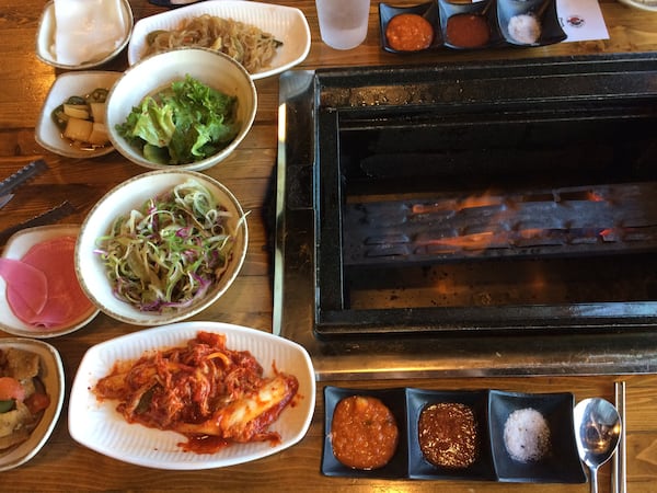 The table is set with banchan while the grill heats up at K-BBQ Factory in Duluth. Refills of the side dishes known as banchan are free. CONTRIBUTED BY WENDELL BROCK