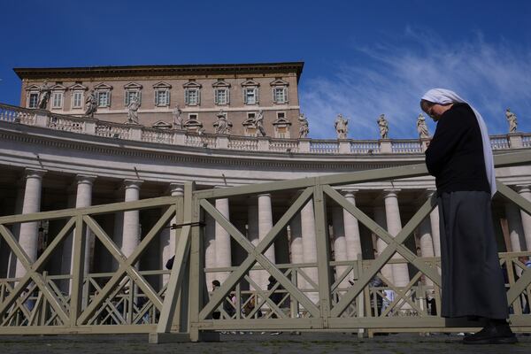 A nun prays towards the window at the Vatican at the time when Pope Francis would usually bestow his blessing, the Pontiff is currently recovering from a bilateral pneumonia at Rome's Agostino Gemelli Polyclinic, in Rome, Sunday, March 2, 2025. (AP Photo/Kirsty Wigglesworth)