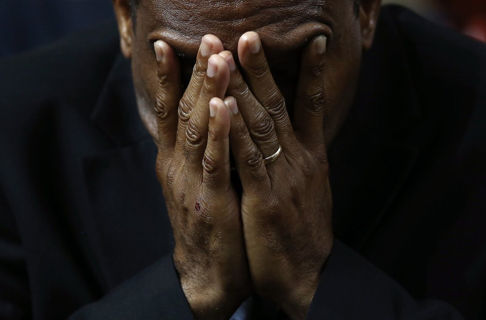 A mourner bows his head in prayer during the funeral service where President Barack Obama delivered the eulogy for the Rev. Clementa Pinckney, who was killed along with eight others in a June 17, 2015, mass shooting in Charleston, S.C. WIN MCNAMEE / GETTY IMAGES