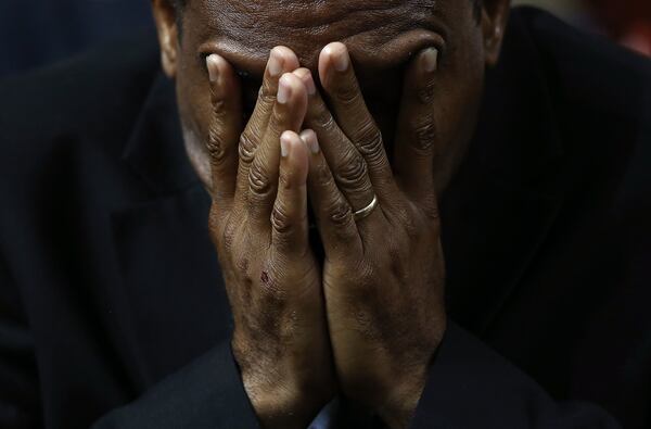 A mourner bows his head in prayer during the funeral service where President Barack Obama delivered the eulogy for the Rev. Clementa Pinckney, who was killed along with eight others in a June 17, 2015, mass shooting in Charleston, S.C. WIN MCNAMEE / GETTY IMAGES