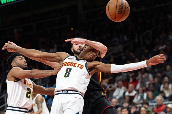 Denver Nuggets forward Peyton Watson (8) meets Atlanta Hawks forward Larry Nance Jr. (22) during the first half of an NBA basketball game Sunday, Dec. 8, 2024, in Atlanta. (AP Photo/John Bazemore)