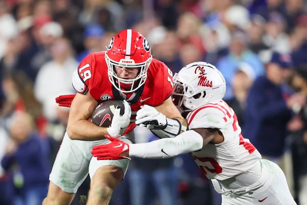 Georgia tight end Brock Bowers (19) runs after a catch against Mississippi safety Trey Washington (25) during their game at Sanford Stadium, Saturday, November 11, 2023, in Athens, Ga. Georgia won 52-17. (Jason Getz / Jason.Getz@ajc.com)