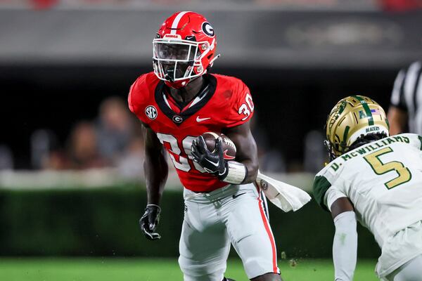 Georgia running back Daijun Edwards (30) runs against Alabama-Birmingham cornerback Mac McWilliams (5) at Sanford Stadium, Saturday, September 23, 2023, in Athens, Ga. Georgia won 49-21. (Jason Getz / Jason.Getz@ajc.com)