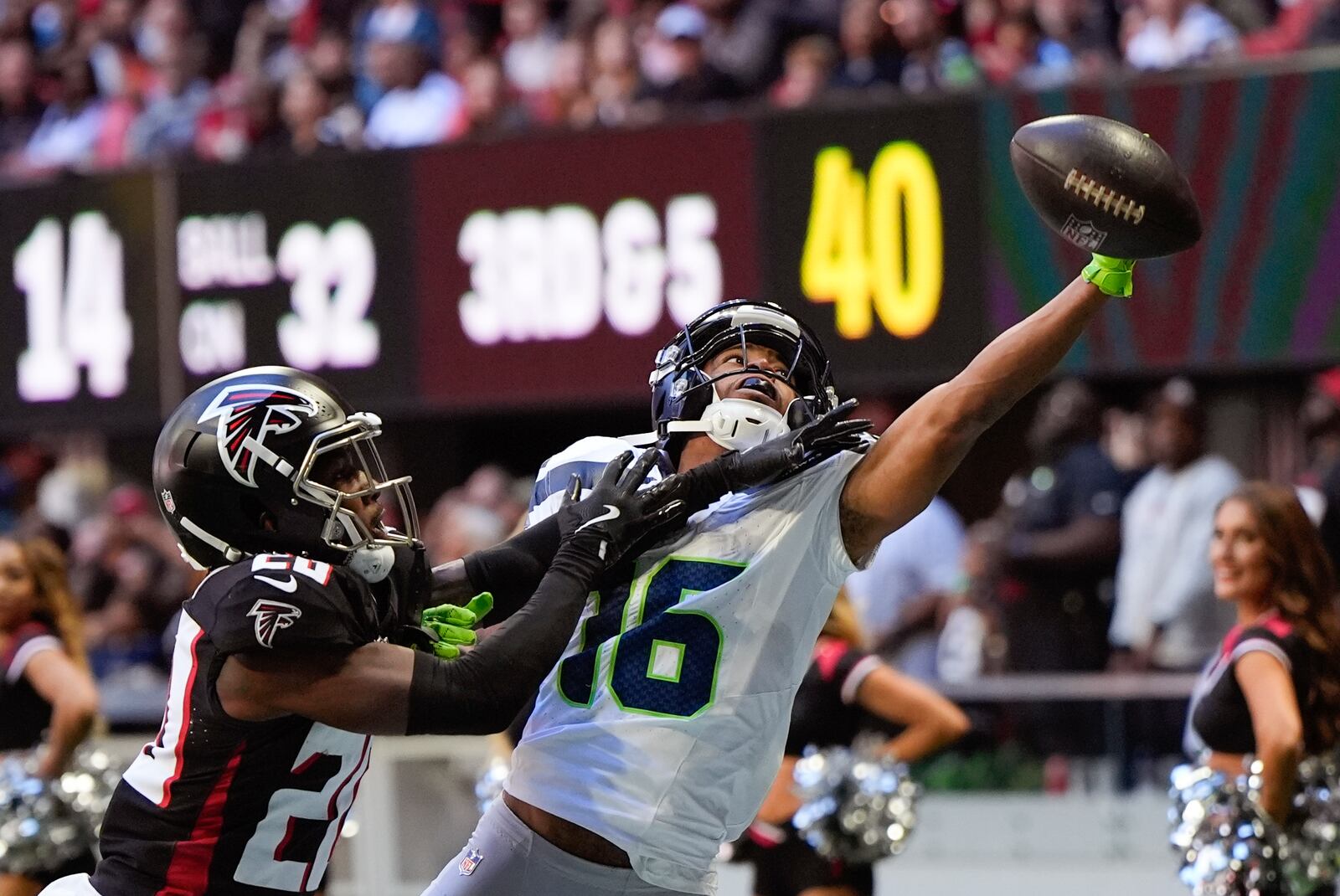 Atlanta Falcons cornerback Dee Alford (20) breaks up a pass intended for Seattle Seahawks wide receiver Tyler Lockett (16) during the second half of an NFL football game, Sunday, Oct. 20, 2024, in Atlanta. (AP Photo/Mike Stewart)