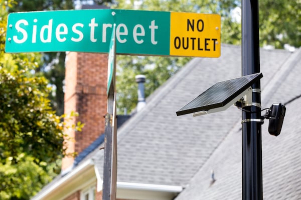 A Flock license plate reader, powered by a solar panel, is shown in the Sidestreet subdivision in Brookhaven. The license plate reader takes a picture of each license plate that enters the neighborhood and keeps track of each vehicle’s comings and goings. The five board members of the neighborhood’s homeowners association have access to the camera’s records.(Casey Sykes for The Atlanta Journal-Constitution)