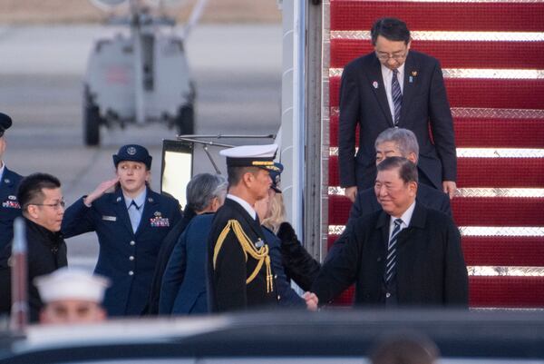 Japan Prime Minister Shigeru Ishiba shakes hands as he is welcomed to Joint Base Andrews in Maryland on Thursday.