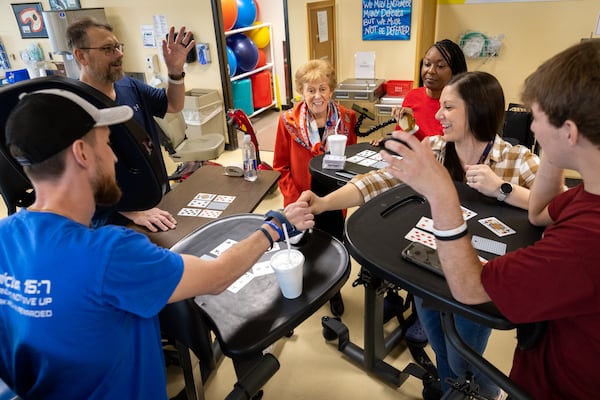 Alana Shepherd (center), founder of Shepherd Center, watches staff and patients play a game at the Shepherd Center in Atlanta on Tuesday, March 12, 2024. (Arvin Temkar / arvin.temkar@ajc.com)