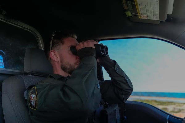 Conservation officer Sgt. Ian Van Nest scans the area for polar bears, Tuesday, Aug. 6, 2024, in Churchill, Manitoba. (AP Photo/Joshua A. Bickel)