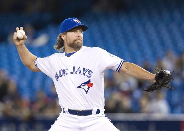 Knuckleballer R.A. Dickey, who's 42, got a kick out of finding out he wouldn't even be the oldest Brave in 2017. He signed a one-year contract with Atlanta a day before Bartolo Colon did the same. (Fred Thornill/The Canadian Press via AP)