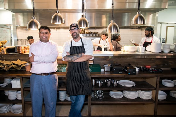 Owner Sandeep Kothary and chef Bhavesh Patel (from left to right) in front of Amara's open kitchen. Photo credit: Mia Yakel.