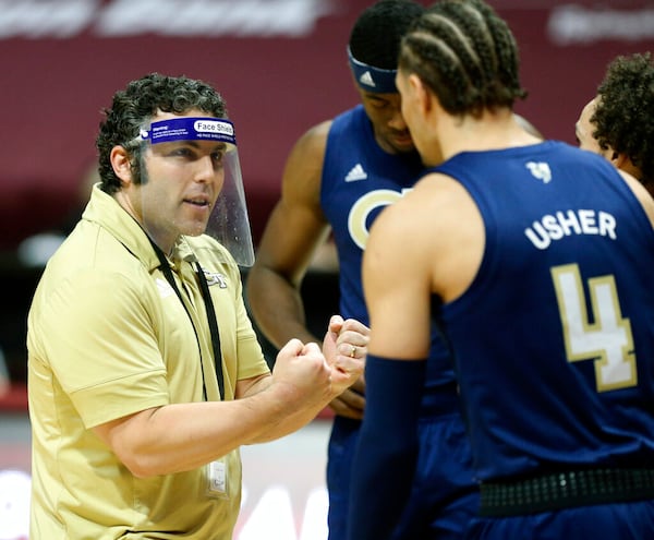 Georgia Tech head coach Josh Pastner speaks with Jordan Usher (4) during the first half of an NCAA college basketball game against Virginia Tech Tuesday, Feb. 23, 2021, in Blacksburg, Va. (Matt Gentry/The Roanoke Times via AP, Pool)