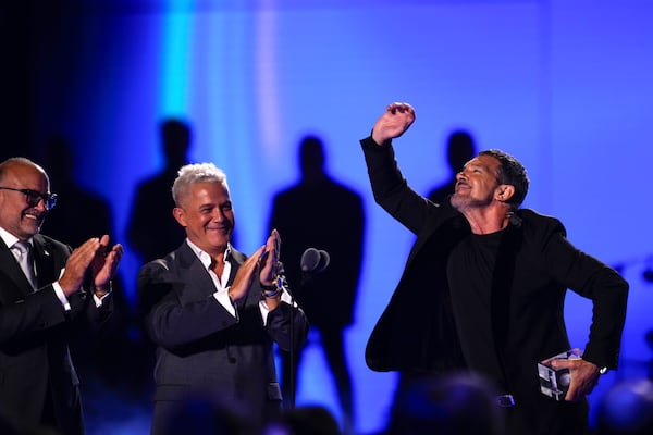 FILE - CEO of the Latin Recording Academy Manuel Abud, left, and Alejandro Sanz, applaud after presenting the president's award to Antonio Banderas during the 24th Annual Latin Grammy Awards, in Seville, Spain, Nov. 16, 2023. (Photo by Jose Breton/Invision/AP File)