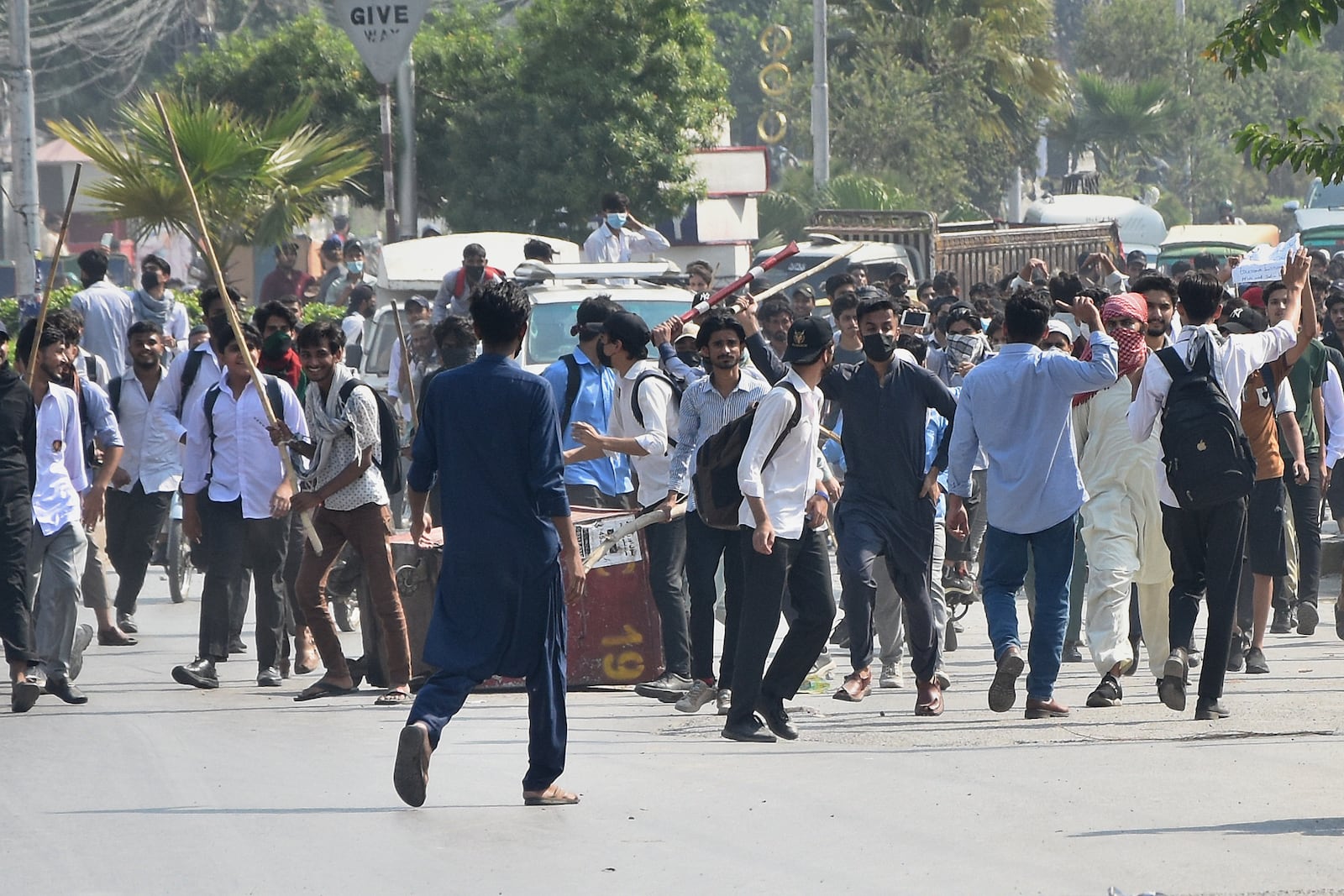 Students throw stones toward police during clashes as they protest over an alleged on-campus rape in Punjab, in Rawalpindi, Pakistan, Thursday, Oct. 17, 2024. (AP Photo/W.K. Yousafzai)