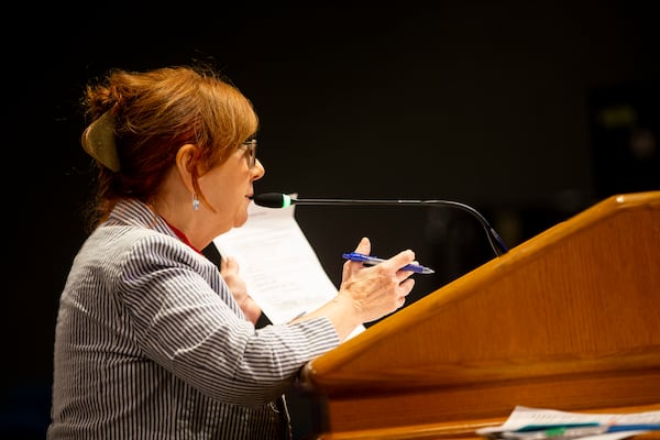 Merry Belle Hodges, a citizen challenging voter eligibility, holds up a voter’s records while speaking during a Gwinnett County election board meeting July 20 at the Gwinnett County Justice and Administration Center in Lawrenceville. (Chris Day/Christopher.Day@ajc.com)