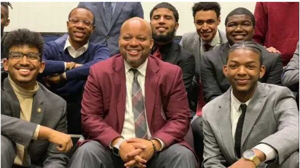 Morehouse College debate coach Kenneth Newby (center) and members of his team. Photo Credit: The Undefeated.