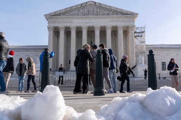 A school group looks at the Supreme Court in the snow, Friday, Jan. 10, 2025, as the court discusses TikTok, in Washington. (AP Photo/Jacquelyn Martin)