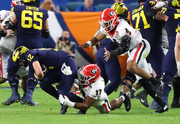 Georgia Bulldogs linebacker Nakobe Dean (17) sacks  Michigan Wolverines quarterback Cade McNamara (12) in the 2nd quarter of the 2021 College Football Playoff Semifinal between the Georgia Bulldogs and the Michigan Wolverines at the Orange Bowl at Hard Rock Stadium in Miami Gardens. Curtis Compton / Curtis.Compton@ajc.com 