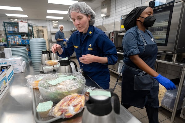 From left, cook Jeff Tait, nutrition research manager Merel Kozlosky, and research dietitian Sharonne Waters prepare a meal for college student and research subject Sam Srisatta in a kitchen as part of a study on the health effects of ultraprocessed foods at the National Institutes of Health in Bethesda, Md., on Thursday, Oct. 31, 2024. (AP Photo/Mark Schiefelbein)