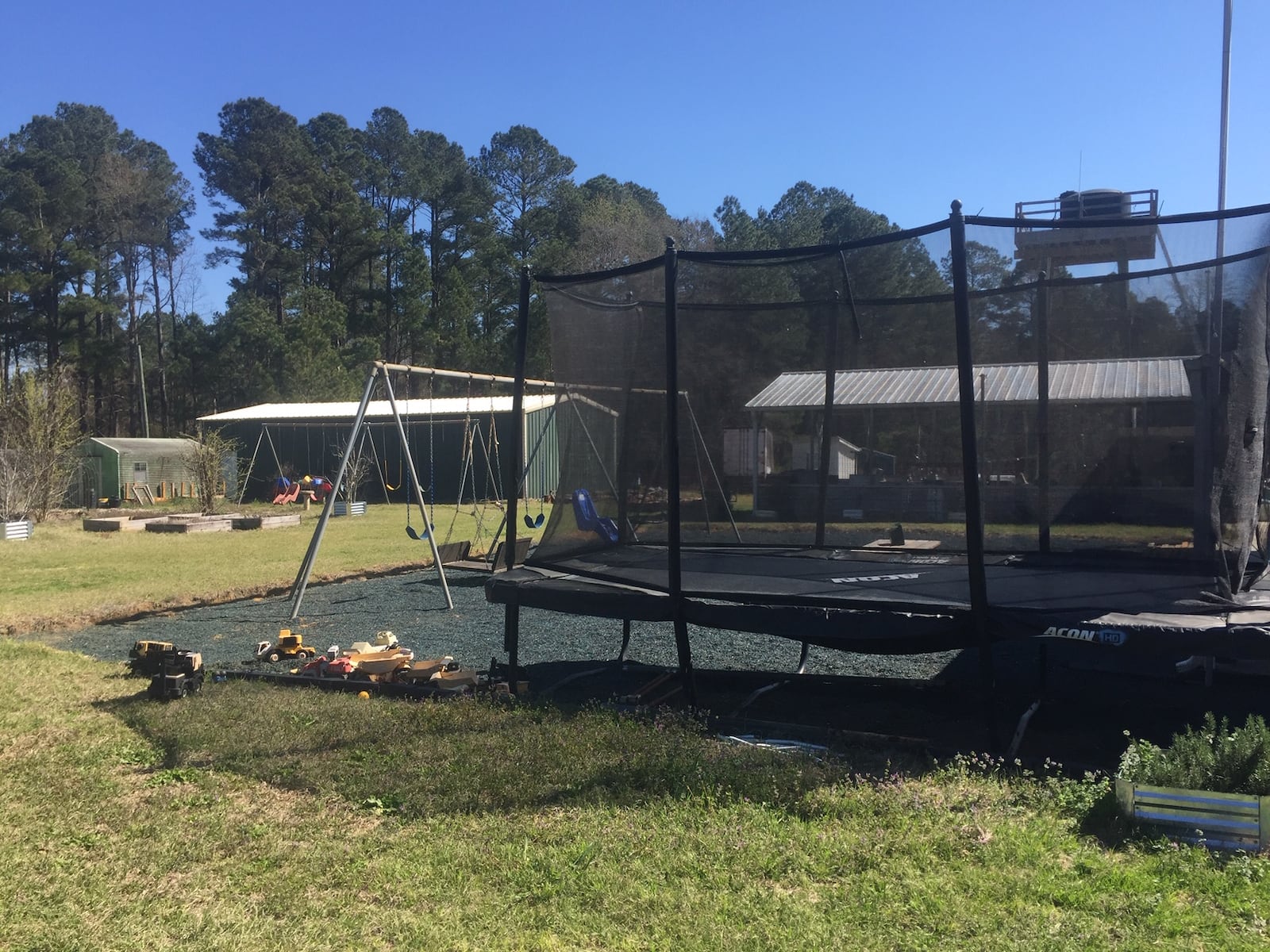 The King's Cleft property, near Wrightsville, where the Faheys cared for children with severe disabilities, has a trampoline and swing sets, along with farm animals, a windmill and a water tower. (Johnny Edwards / Johnny.Edwards@ajc.com)