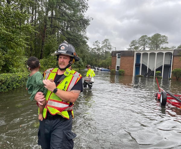 A Valdosta firefighter rescues a small child in a flooded area caused by rains from Hurricane Idalia on Aug. 30, 2023. Idalia was the strongest storm to make landfall in the U.S. in 2023. (courtesy of Valdosta Fire Department)