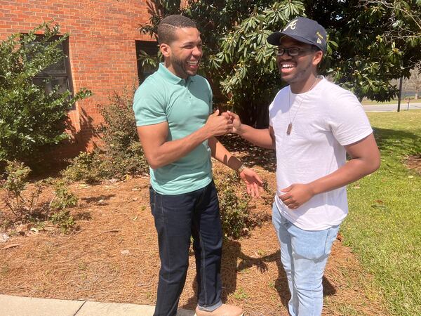 East Georgia State College professor Antré Drummer shares a laugh with student Aaron Penn. Drummer has become a mentor to Penn, 21, an aspiring film producer. College administrators say such relationships are important to help students succeed at the small school. (Eric Stirgus / Eric.Stirgus@ajc.com) 