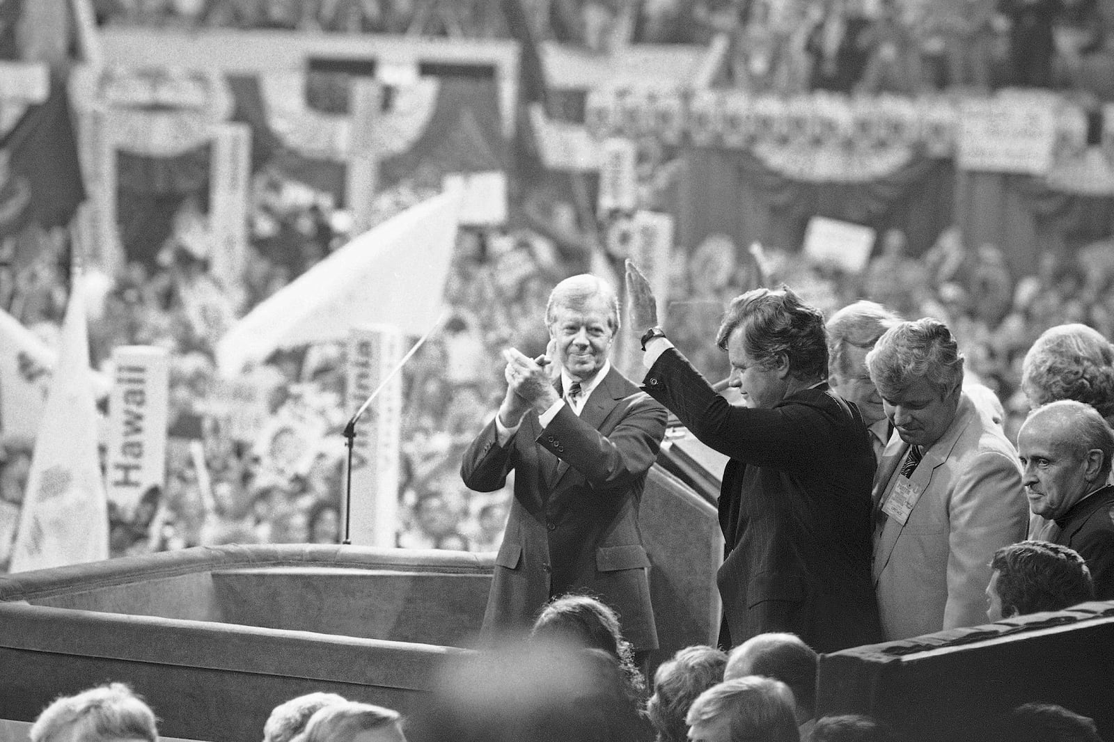 FILE - President Jimmy Carter applauds as Sen. Edward Kennedy waves to cheering crowds of the Democratic National Convention at New York's Madison Square Garden, Aug. 14, 1980. (AP Photo/Bob Daugherty, File)