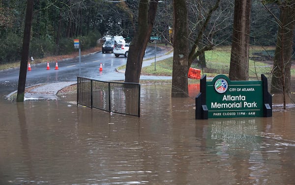 Cars turn around before floodwaters covering parts of Peachtree Battle Ave after the Peachtree Creek overflowed it's banks with rain water on Friday December 28th, 2018. (Photo by Phil Skinner)