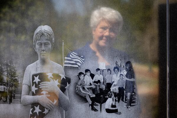 Margo Truett looks at an image of her family engraved on a replica Vietnam War Memorial wall at the National Infantry Museum in Columbus. Her mother, Marilyn, made a vow to Truett and her siblings immediately after she told them their father wasn’t coming home. According to Truett, she told them, “I love all of you so much, and I will do everything that I can do to take care of you.”(Arvin Temkar / arvin.temkar@ajc.com)