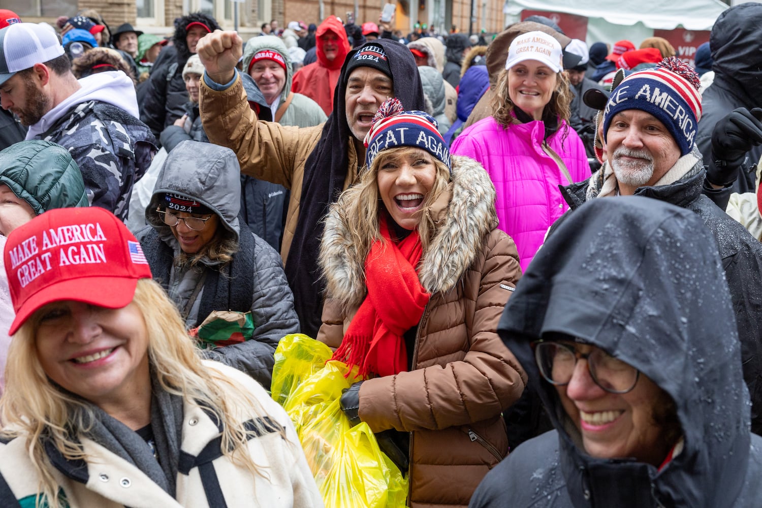 Trump supporters cheer for a video crew while waiting to enter a Trump rally at Capital One Arena in Washington, D.C. on Sunday, January 19, 2025, one day before Donald Trump’s inauguration. (Arvin Temkar / AJC)